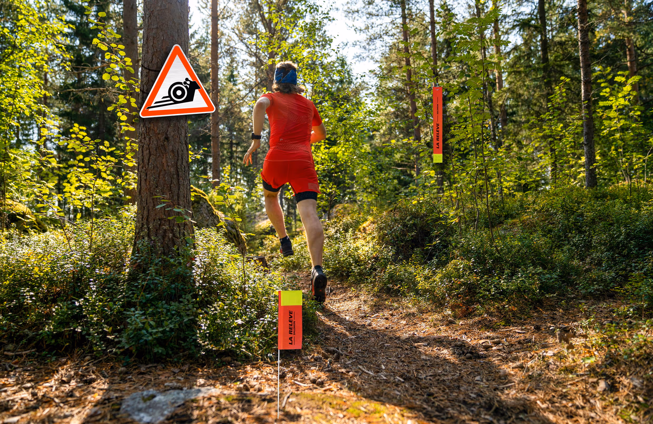 Coureur de trail en forêt passant près d’une signalétique La Relève avec pictogramme escargot